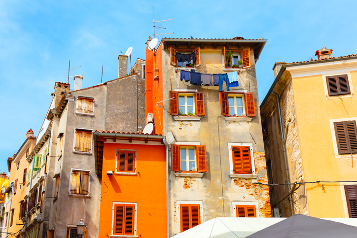 Colorful houses of Old Town Rovinj from Croatia. Row of buildings with orange and yellow facades.