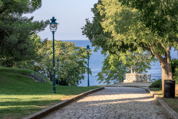 Rovinj, Croatia square with trees in historic old town and sea view
