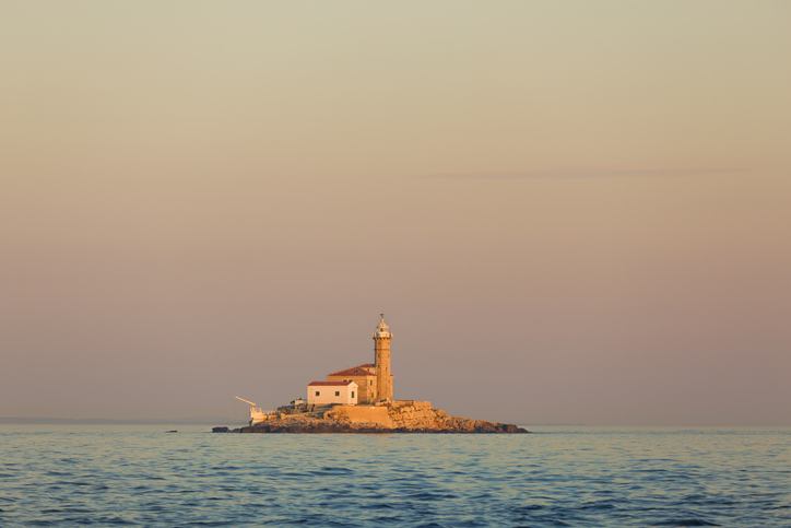 St. John lighthouse in the sea, lit by the evening sun, Rovinj, Croatia